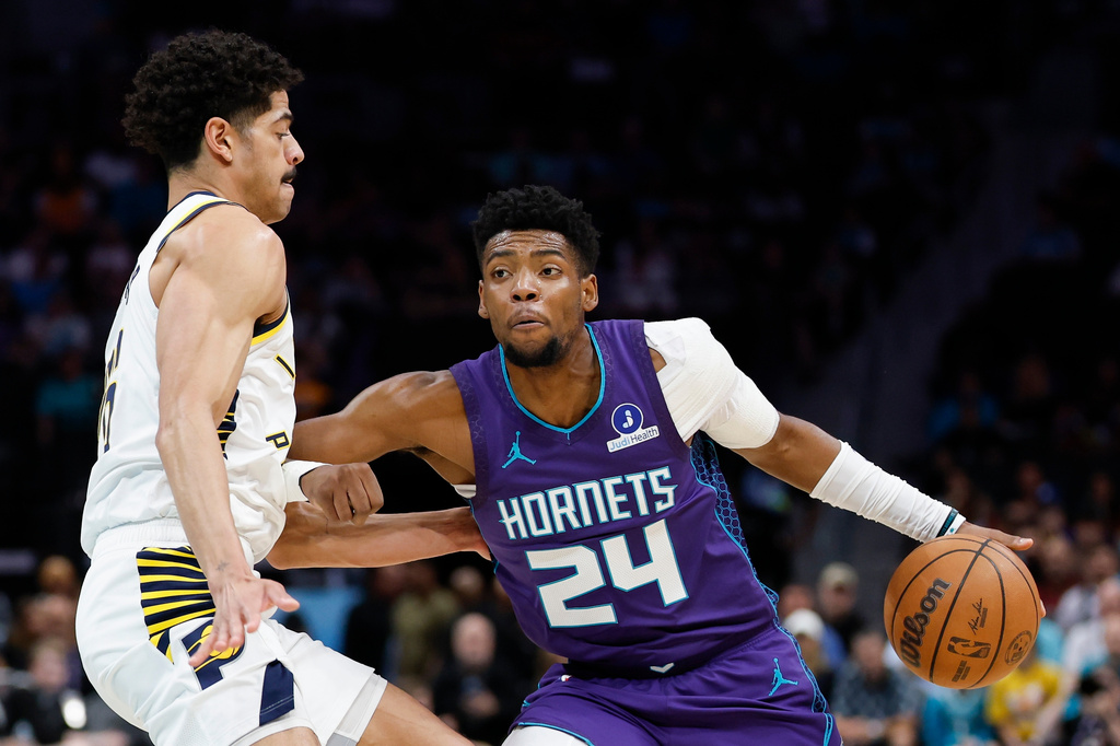 Charlotte Hornets forward Brandon Miller (24) drives to the basket against Indiana Pacers guard Ben Sheppard, left, during the first half of an NBA basketball game in Charlotte, N.C., Friday, April 3, 2026. (AP Photo/Nell Redmond)