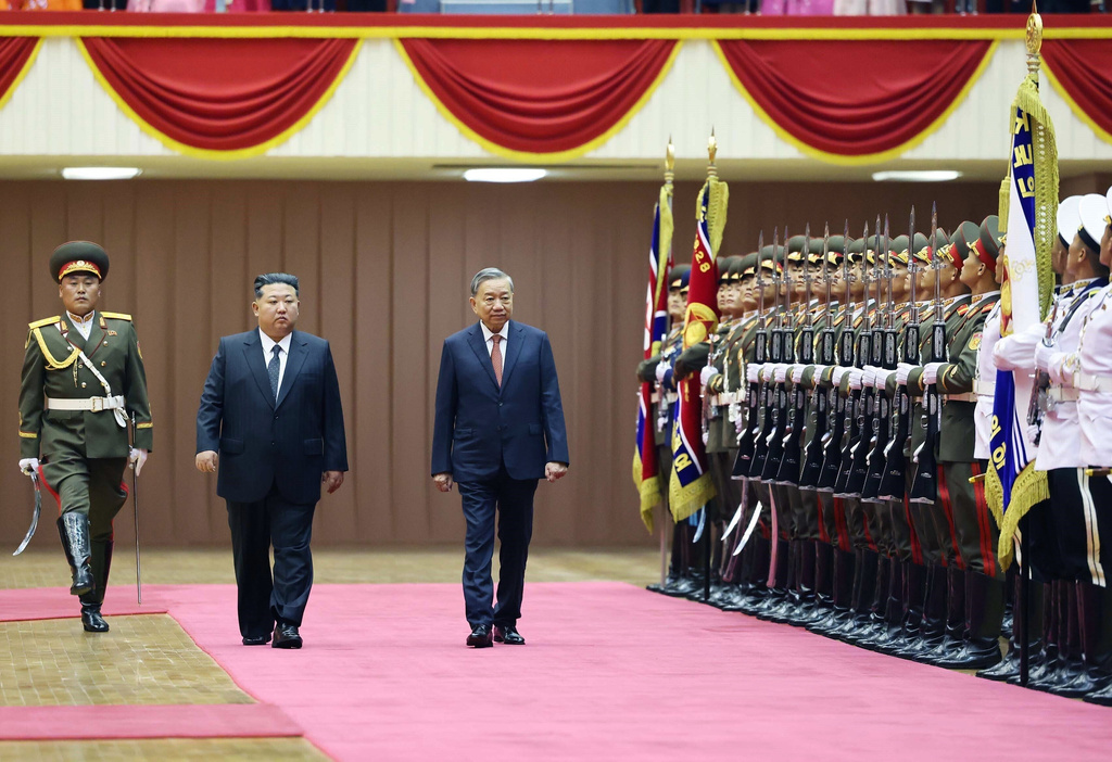 North Korean leader Kim Jong Un, second left, and Vietnamese General Secretary of Communist Party To Lam, third left, review honor guards during a welcome ceremony for Lam's state visit in Pyongyang, North Korea, Thursday, Oct. 9, 2025. (Hoang Thong Nhat/VNA via AP)