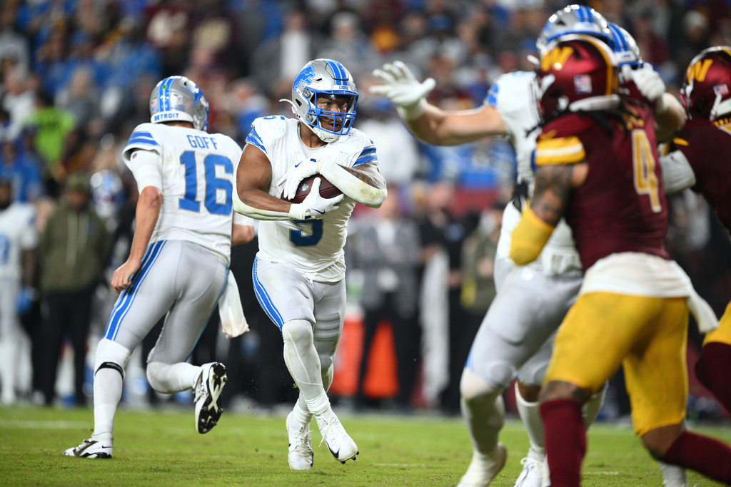 Detroit Lions running back David Montgomery (5) runs with the ball during the first half of an NFL football game against the Washington Commanders Sunday, Nov. 9, 2025, in Landover, Md. (AP Photo/Nick Wass)
