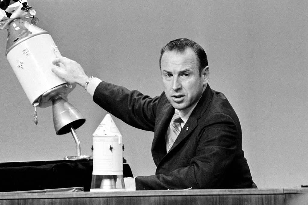 FILE - Apollo 13 commander James A. Lovell speaks during a televised news conference at the Manned Spacecraft Center in Houston, Texas, April 21, 1970, pointing to the spot on the service module where an explosion ripped a panel loose. (AP Photo/Dave Taylor, File)