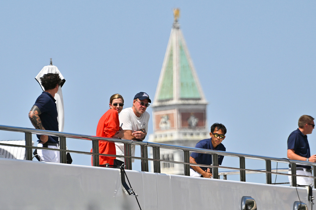 U.S. Ambassador to Italy Tilman Fertitta, center, with his wife Lauren Ware, second from left, is backdropped by the bell tower of St. Mark's Basilica upon arrival in Venice, Italy, Friday, July 17, 2026, aboard his super yacht, Boardwalk, as part of his "Freedom 250 Coastal Diplomacy" tour.(AP Photo/Luigi Costantini)