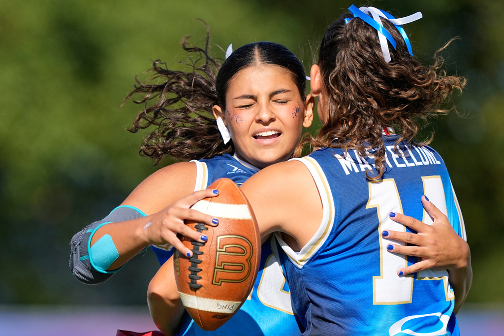 Italy's Andrea Ferro Avolese celebrates with Lucia Bernadette Nigro Mastellone during the Flag Football World Championship women's match between Italy and Slovenia in Duesseldorf, Germany, Thursday, Aug. 13, 2026. (AP Photo/Martin Meissner)