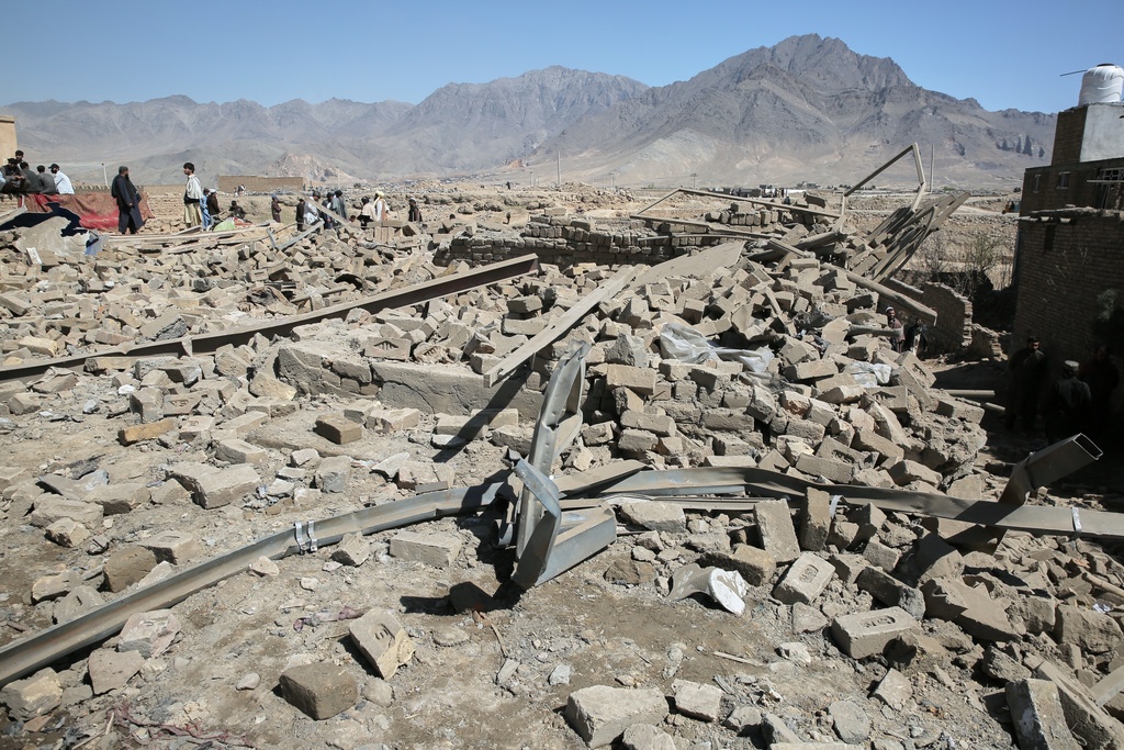 Residents gather at the site of a strike in Kabul, Afghanistan, Friday, March 13, 2026. (AP Photo/Barackatullah Popal)