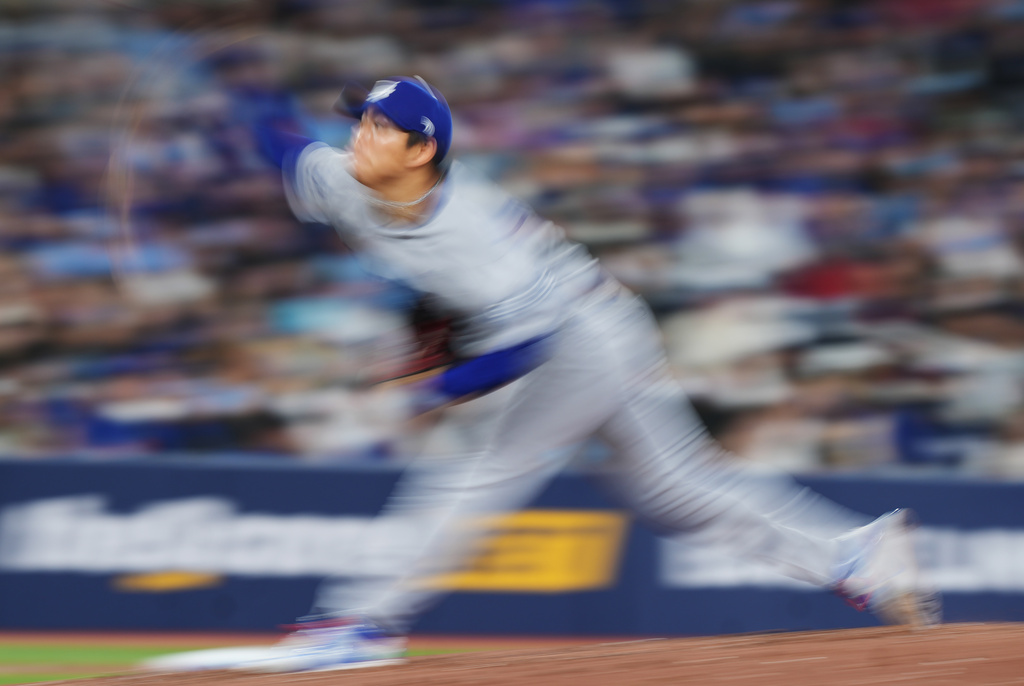Los Angeles Dodgers pitcher Yoshinobu Yamamoto (18) works against the Toronto Blue Jays during the sixth inning of an MLB baseball game in Toronto on Tuesday, April 7, 2026. (Nathan Denette/The Canadian Press via AP)