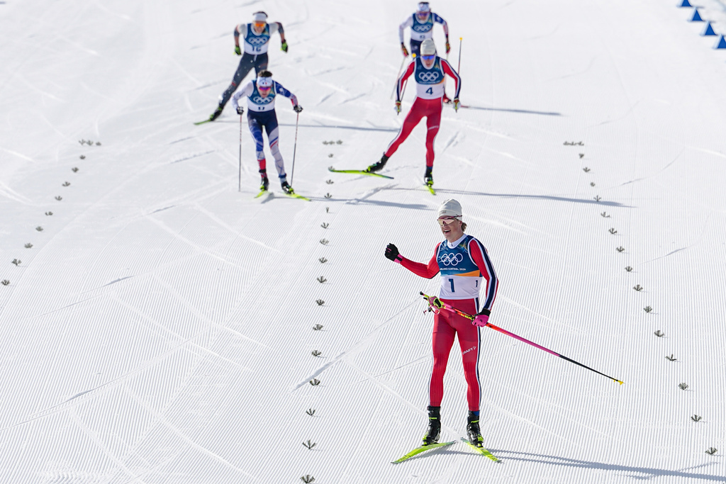 Johannes Hoesflot Klaebo, of Norway, approaches the finish line to win the gold medal in the cross country skiing men's 10km + 10km skiathlon at the 2026 Winter Olympics, in Tesero, Italy, Sunday, Feb. 8, 2026. (AP Photo/Matthias Schrader)