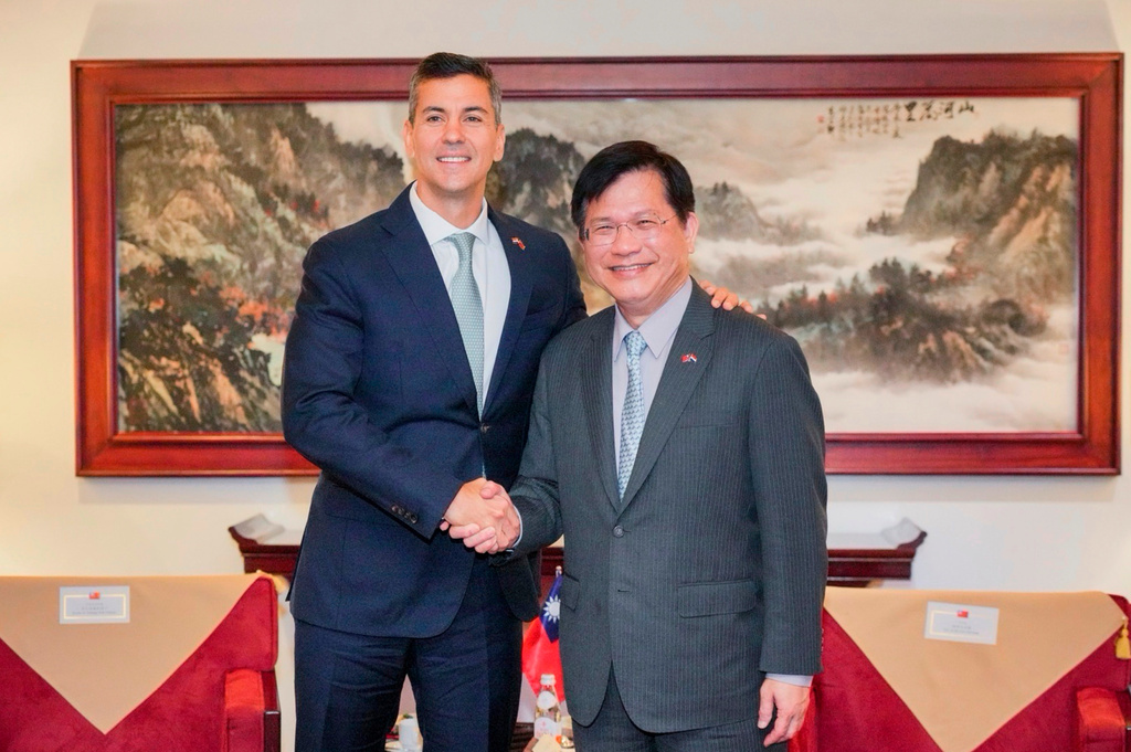 In this image taken from video released by the Taiwan Ministry of Foreign Affairs, Paraguayan President Santiago Peña, left, is greeted by Taiwan's Foreign Minister Lin Chia-lung upon arrival in Taipei, Taiwan on Thursday, May 7, 2026. (Taiwan Ministry of Foreign Affairs via AP)
