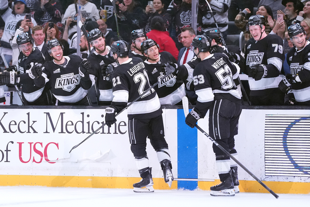 The Los Angeles Kings' bench greets center Scott Laughton (21) and right wing Jared Wright (53) after Laughton's goal against the Nashville Predators during the second period of an NHL hockey game Monday, April 6, 2026, in Los Angeles. (AP Photo/Scott Strazzante)