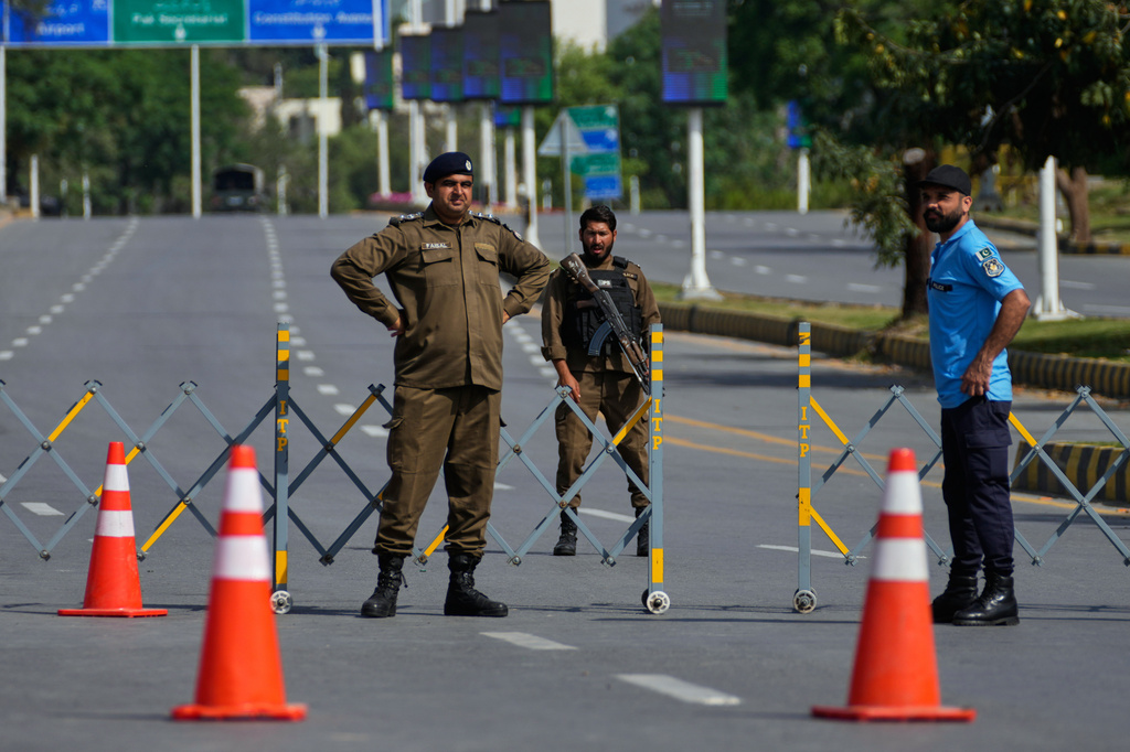 Police officers stand guard at a checkpoint on a barricaded ahead of the second round of negotiations between the U.S. and Iran, in Islamabad, Pakistan, Tuesday, April 21, 2026. (AP Photo/Anjum Naveed)