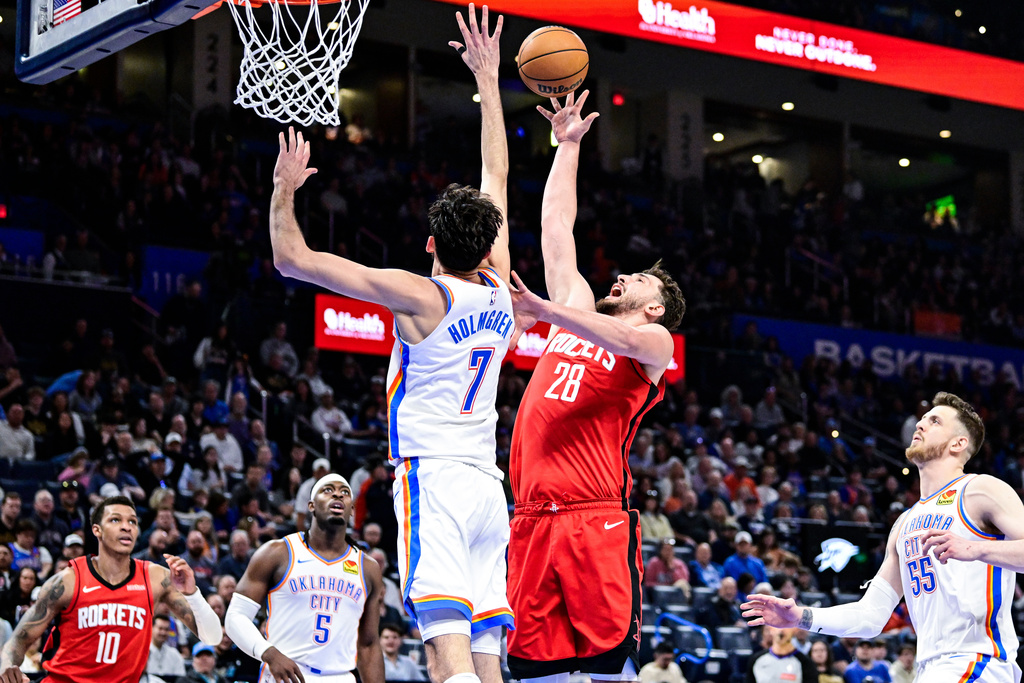 Houston Rockets center Alperen Sengun (28) shoots against Oklahoma City Thunder center/forward Chet Holmgren (7) during the second half of an NBA basketball game Saturday, Feb. 7, 2026, in Oklahoma City. (AP Photo/Gerald Leong)