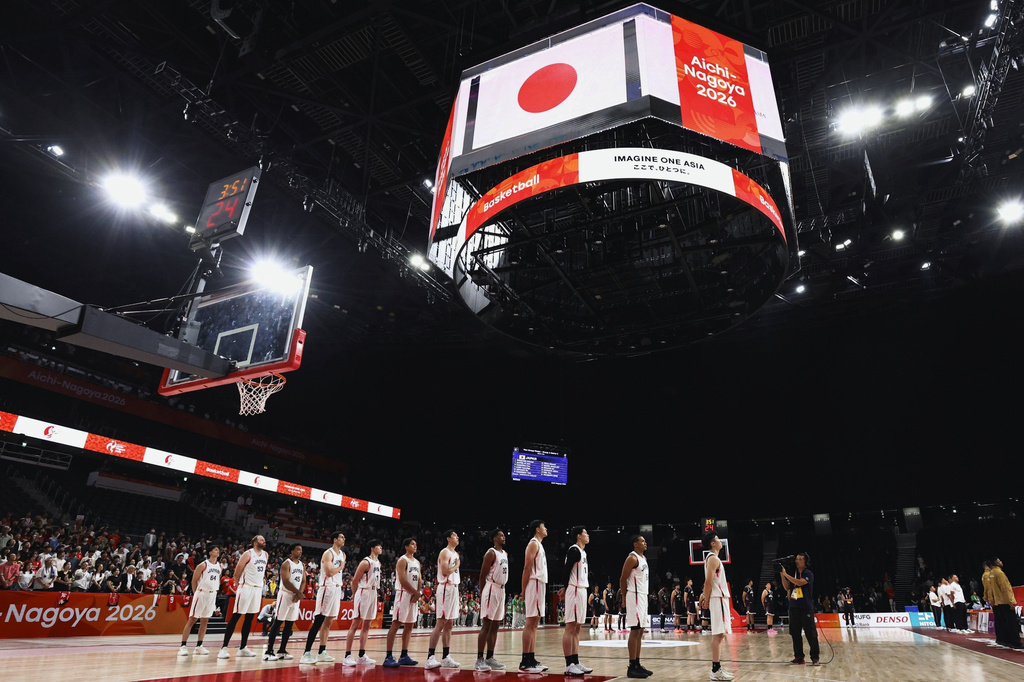 Members of the team Japan listen to their national anthem before their basketball game against Indonesia in the Asian Games in Nagoya, central Japan, on Sept. 10, 2026. (Takehito Nakamoto/Kyodo News via AP)