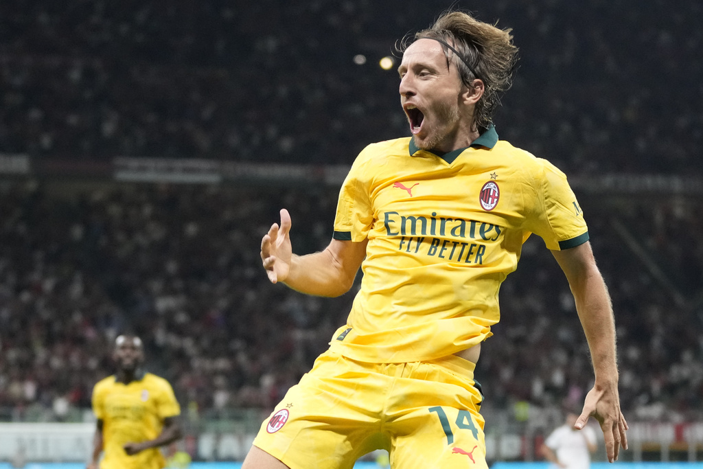 AC Milan's Luka Modric celebrates after scoring his side's opening goal during a Serie A soccer match between AC Milan and Bologna at San Siro stadium in Milan, Italy, Sunday, Sept. 14, 2025. (AP Photo/Luca Bruno)