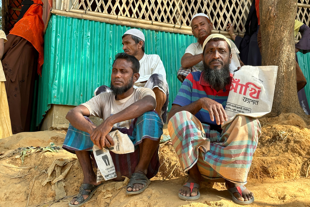 FILE - Rohingya refugees wait for food to be distributed during the Islamic holy month of Ramadan at their camp in Cox's Bazar, Bangladesh, March 6, 2025. (AP Photo/Shafiqur Rahman, File)