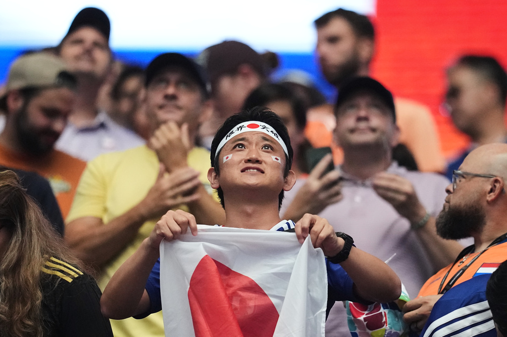 A fan of Japan holds his country's flag prior to the World Cup Group F soccer match between the Netherlands and Japan in Arlington, Texas, near Dallas, Sunday, June 14, 2026. (AP Photo/Julio Cortez)