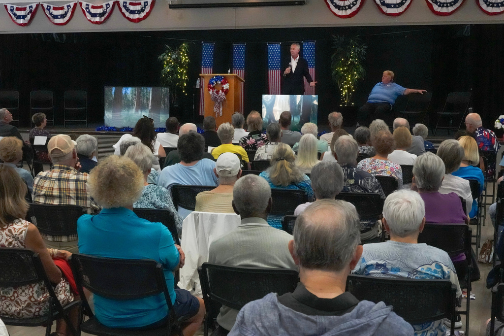 Florida Democratic gubernatorial candidate David Jolly, back center, speaks to voters during a town hall meeting, Saturday, Aug. 8, 2026, in Leesburg, Fla. (AP Photo/John Raoux)