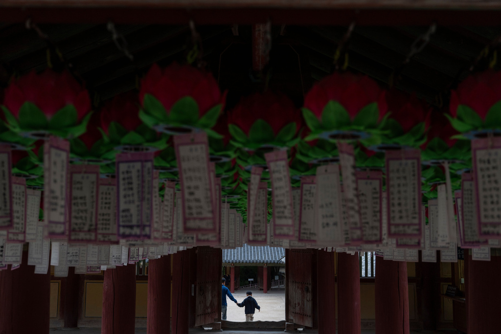 Visitors pass near lanterns at Bulguksa Temple where preparations are underway ahead of events for attendees of the Asia-Pacific Economic Cooperation (APEC) summits in Gyeongju, South Korea, Thursday, Oct. 30, 2025. (AP Photo/Ng Han Guan)