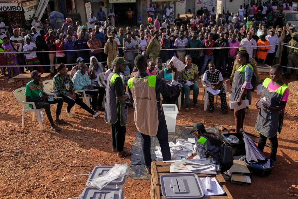 Election officials count ballots after the polls closed for the presidential election at a polling station in Kampala, Uganda, Thursday, Jan. 15, 2026. (AP Photo/Brian Inganga)