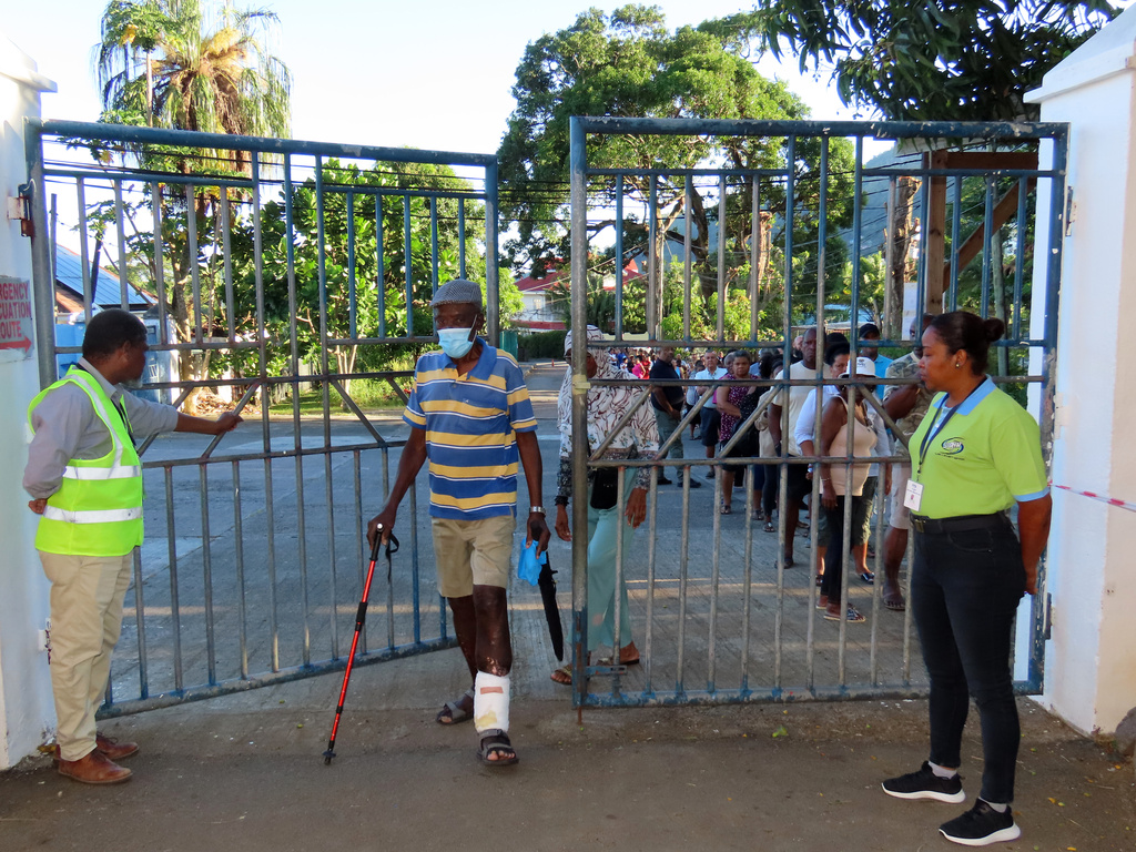 People line up to cast their votes in a runoff presidential election at Mont Fleuri Secondary School, Mont Fleuri, Mahe, Seychelles, Saturday, Oct. 11, 2025. (AP Photo/Emilie Chetty)