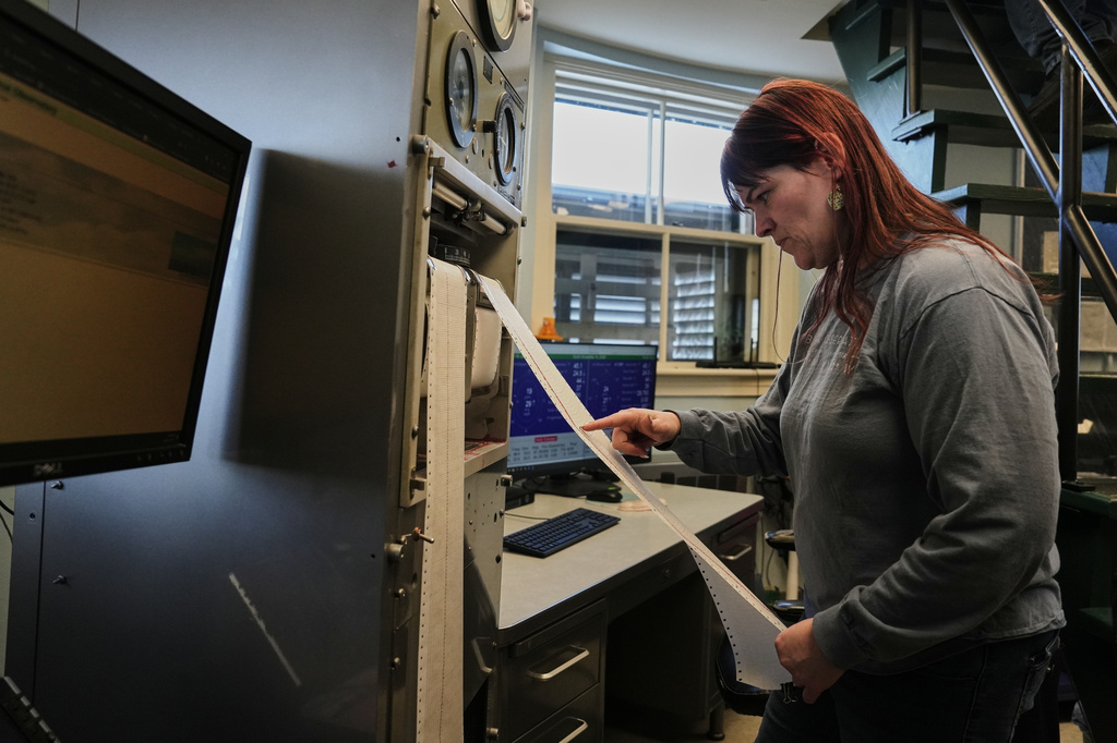 Amanda Joly reads a graph detailing wind data at the Blue Hill Observatory and Science Center, Saturday, March 14, 2026, in Milton, Mass. (Laura Martin Agudelo/MIT Graduate Program in Science Writing via AP)