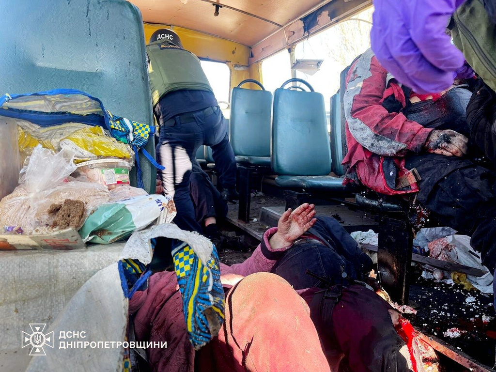 In this photo provided by the Ukrainian Emergency Services on Tuesday, April 7, 2026, rescue workers evacuate injured people from a bus attacked by a Russian drone in Nikopol, Dnipropetrovsk region, Ukraine. (Ukrainian Emergency Service via AP)