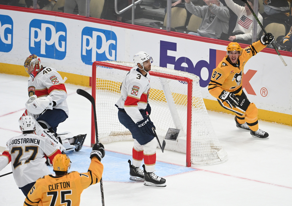 Pittsburgh Penguins center Sidney Crosby (87) celebrates a goal on Florida Panthers goalie Daniil Tarasov (40) as defenseman Connor Clifton (75), center Eetu Luostarinen (27) and defenseman Seth Jones (3) skate nearby during the first period of an NHL hockey game, Sunday, April 5, 2026, in Pittsburgh. (AP Photo/Philip G. Pavely)