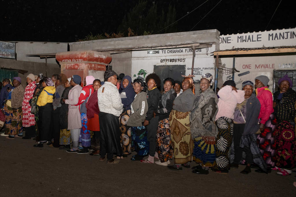 Zambians queue outside a polling station on the outskirts of Lusaka, Zambia, Thursday, Aug. 13, 2026. (AP Photo/Anita Reed)