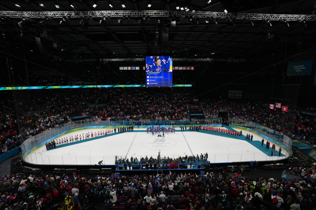 Teams from the United States, Canada and Switzerland receive their medals following the women's ice hockey gold medal game at the 2026 Winter Olympics, in Milan, Italy, Thursday, Feb. 19, 2026. (AP Photo/Carolyn Kaster)