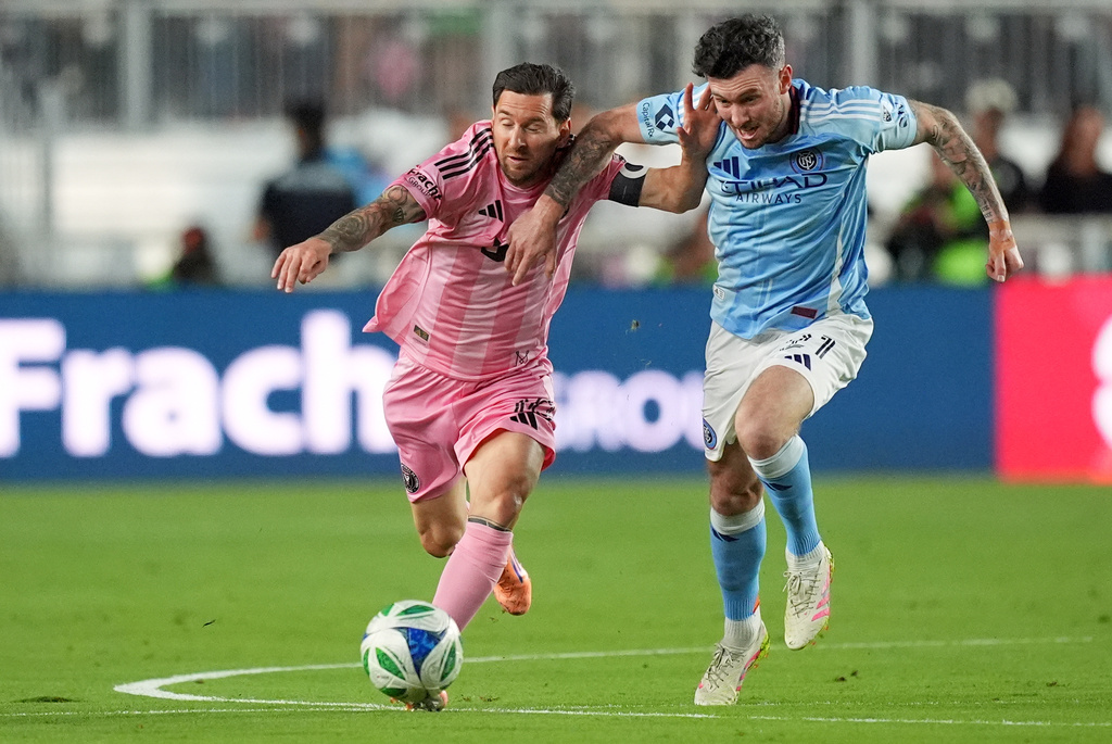 Inter Miami forward Lionel Messi, left,clashes with New York City FC midfielder Aiden O'Neill, right, during the first half of an MLS Eastern Conference final soccer match, Saturday, Nov. 29, 2025, in Fort Lauderdale, Fla. (AP Photo/Rebecca Blackwell)