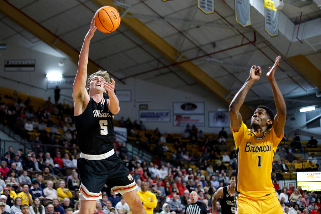 Miami (Ohio) guard Peter Suder (5) shoots against Western Michigan guard Trey Lewis (1) during the first half of an NCAA college basketball game, Friday, Feb. 27, 2026, in Kalamazoo, Mich. (AP Photo/Al Goldis)