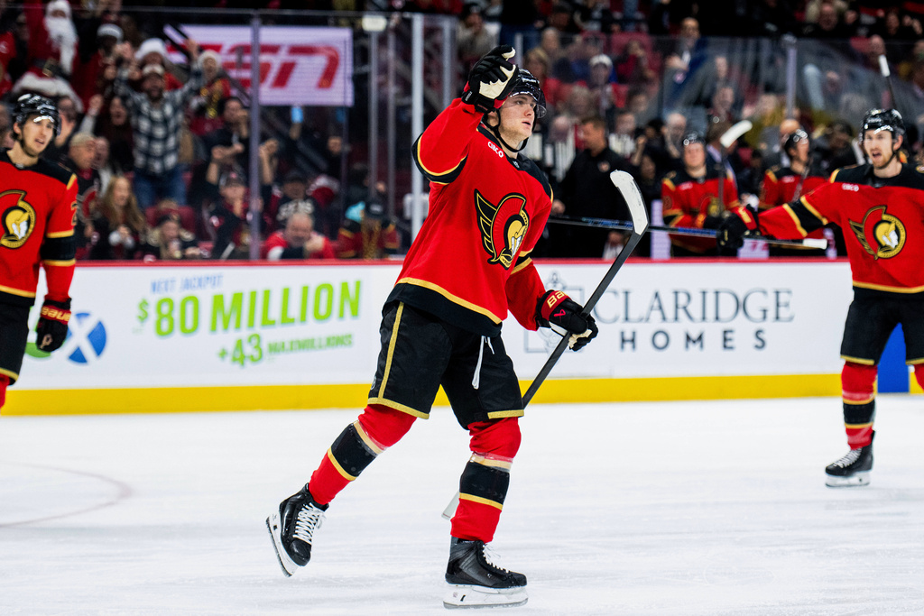 Ottawa Senators' Tim Stutzle (18) celebrates his goal on Buffalo Sabres goaltender Alex Lyon during second period NHL hockey action in Ottawa, Ontario, Tuesday, Dec. 23, 2025. (Spencer Colby/The Canadian Press via AP)