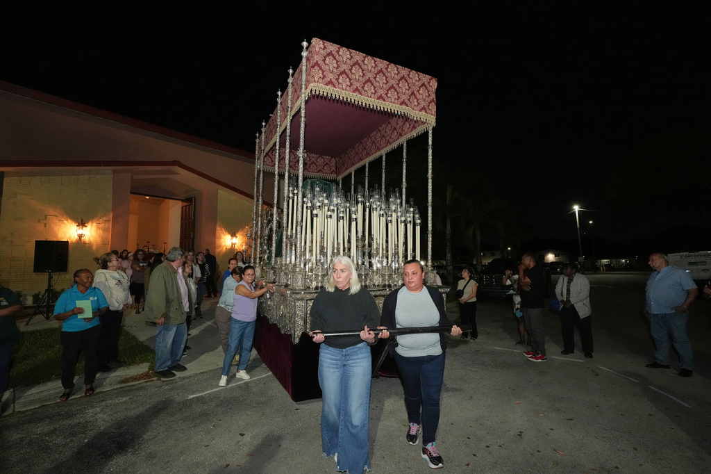 Corpus Christi Catholic Church members push a large float that will carry the Lady of Hope Macarena during a rehearsal for their Good Friday procession, Monday, March 23, 2026, in Miami, Fla. (AP Photo/Marta Lavandier)