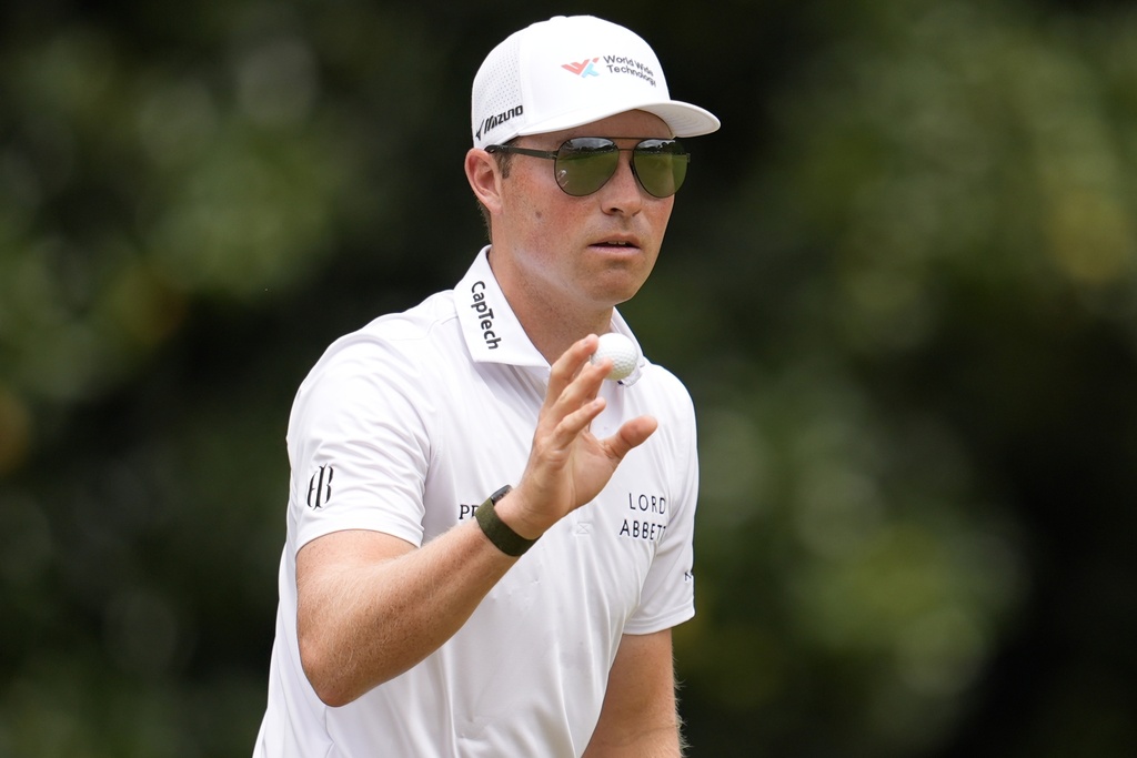 Ben Griffin waves to spectaots on the second green during the third round of the Tour Championship golf tournament, Saturday, Aug. 23, 2025, in Atlanta. (AP Photo/Mike Stewart)