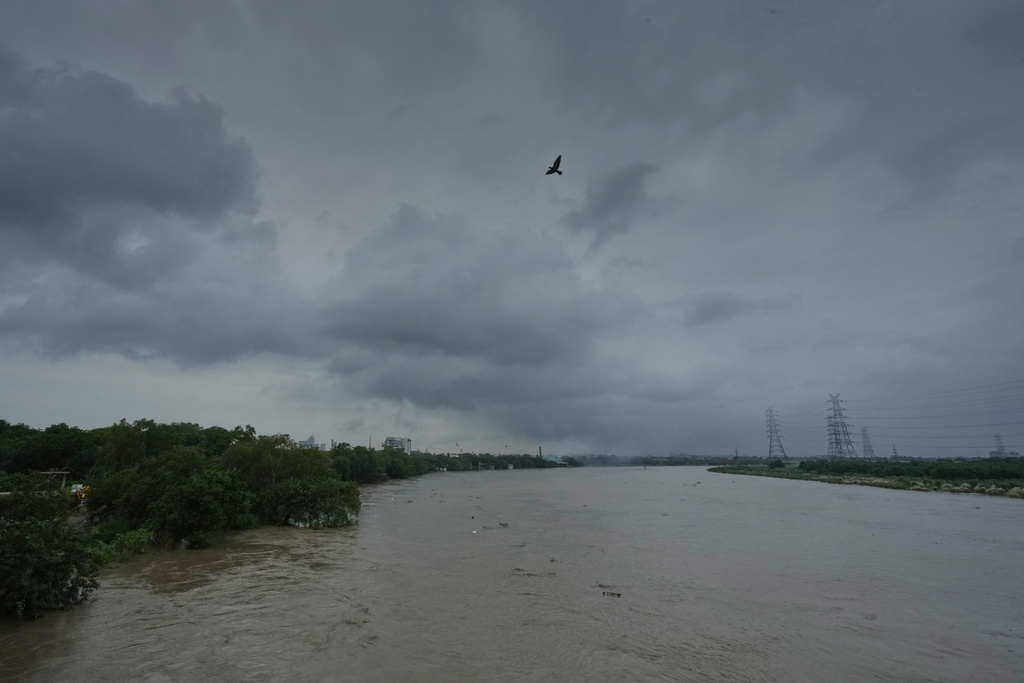 A bird flies over the swollen river Yamuna, in New Delhi, India, Tuesday, Sept. 2, 2025. (AP Photo/Manish Swarup)