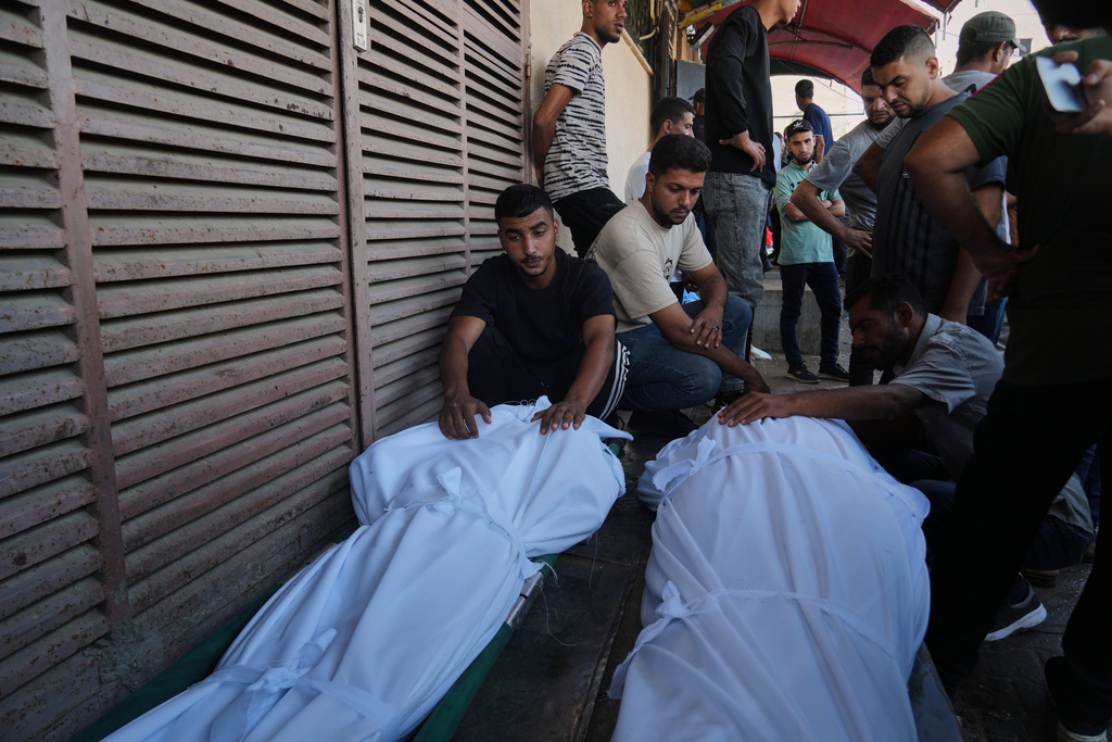 Mourners attend the funeral of Palestinians killed in an Israeli army strike, outside Al-Aqsa Hospital in Deir al-Balah, central Gaza Strip, Saturday, Oct. 4, 2025. (AP Photo/Abdel Kareem Hana)