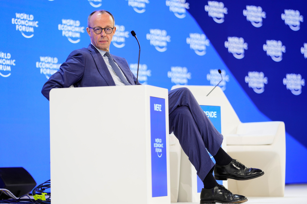 German Chancellor Friedrich Merz sits on the podium during the Annual Meeting of the World Economic Forum in Davos, Switzerland, Thursday, Jan. 22, 2026. (AP Photo/Markus Schreiber)