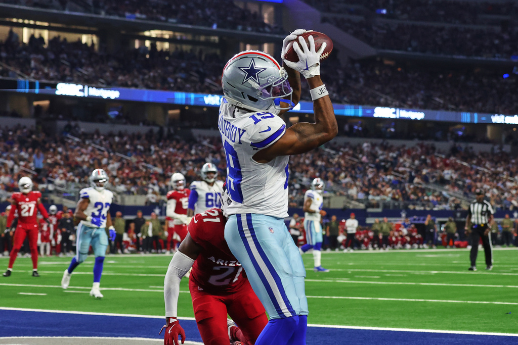 Dallas Cowboys wide receiver Ryan Flournoy (19) catches a touchdown pass as Arizona Cardinals cornerback Garrett Williams (21) defends in the second half of an NFL football game Monday, Nov. 3, 2025, in Arlington, Texas. (AP Photo/Richard Rodriguez)