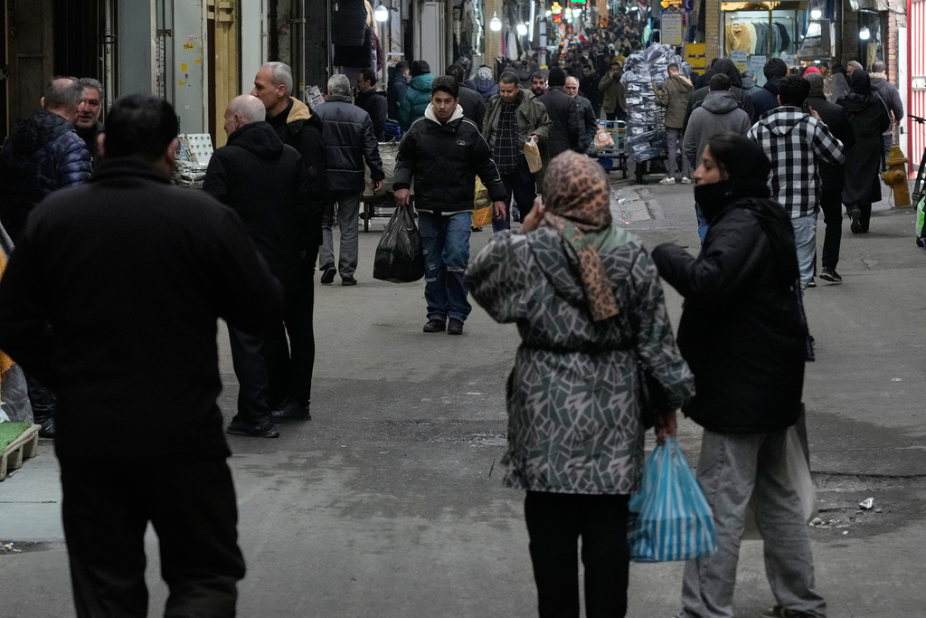 People conduct their businesses at Tehran's historic Grand Bazaar, Tuesday, Jan. 20, 2026, in Iran. (AP Photo/Vahid Salemi)