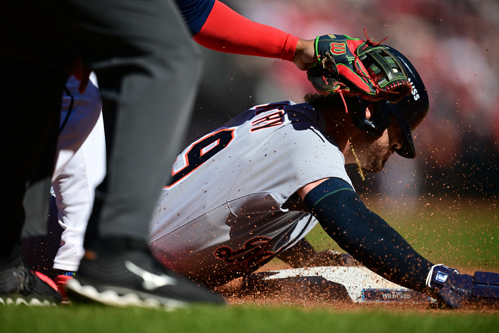 Detroit Tigers' Zach McKinstry slides and is out at third base by Cleveland Guardians third baseman José Ramírez, left, in the fourth inning of Game 2 of the American League Wild Card baseball playoff series in Cleveland, Wednesday, Oct. 1, 2025. (AP Photo/David Dermer)