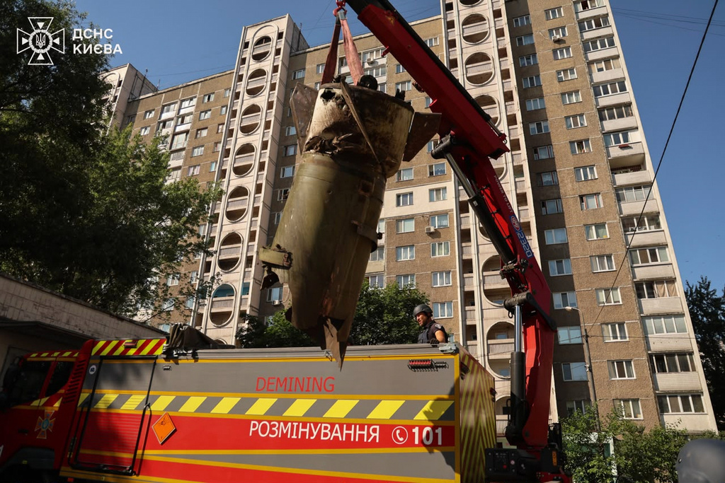 In this photo provided by the Ukrainian Emergency Service, sappers remove a fragment of the Russian missile in a residential neighbourhood following an air attack in Kyiv, Ukraine, Sunday, June 28, 2026. (Ukrainian Emergency Service via AP)