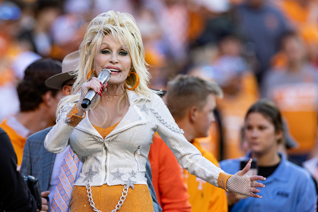 FILE - Dolly Parton performs during the first half of an NCAA college football game between Tennessee and Georgia Nov. 18, 2023, in Knoxville, Tenn. (AP Photo/Wade Payne, File)