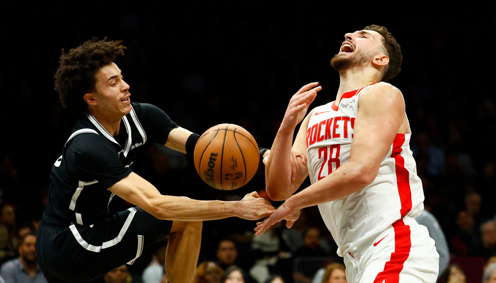 Houston Rockets center Alperen Sengun (28) is fouled by Brooklyn Nets guard Nolan Traore during the first half of an NBA basketball game, Thursday, Jan. 1, 2026, in New York. (AP Photo/Noah K. Murray)