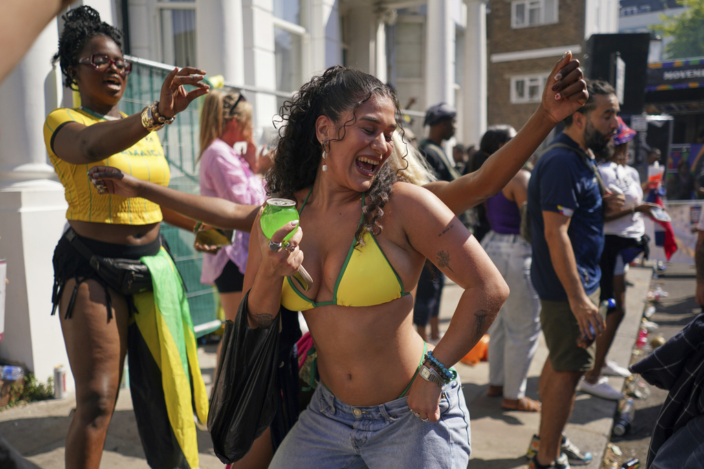 People sing and dance to celebrate Notting Hill Carnival in London, Monday, Aug. 25, 2025, Europe's biggest street party and one of the largest carnivals in the world.(AP Photo/Alberto Pezzali)