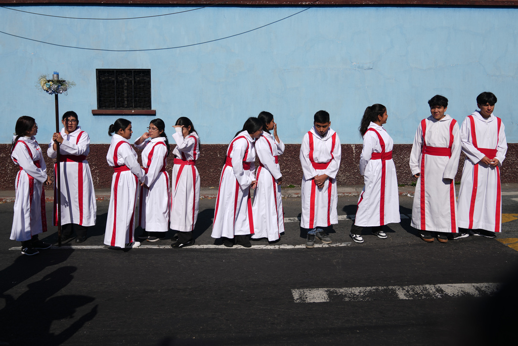 Altar boys and girls line up to take part in a religious procession marking Three Kings Day, also known as feast day of The Epiphany, in the Guardia Viejo neighborhood of Guatemala City, Tuesday, Jan. 6, 2026. (AP Photo/Moises Castillo)