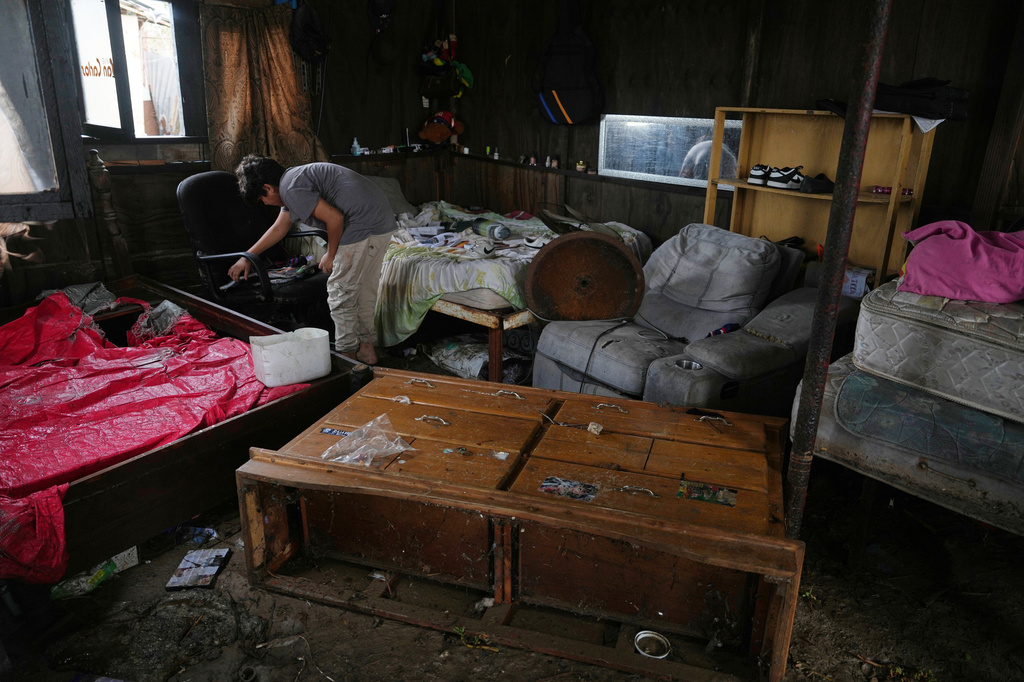 A resident retrieves belongings from their home that was damaged by Hurricane Polo in Puerto San Carlos, Baja California Sur state, Mexico, Tuesday, Sept. 29, 2026. (AP Photo/Eduardo Verdugo)