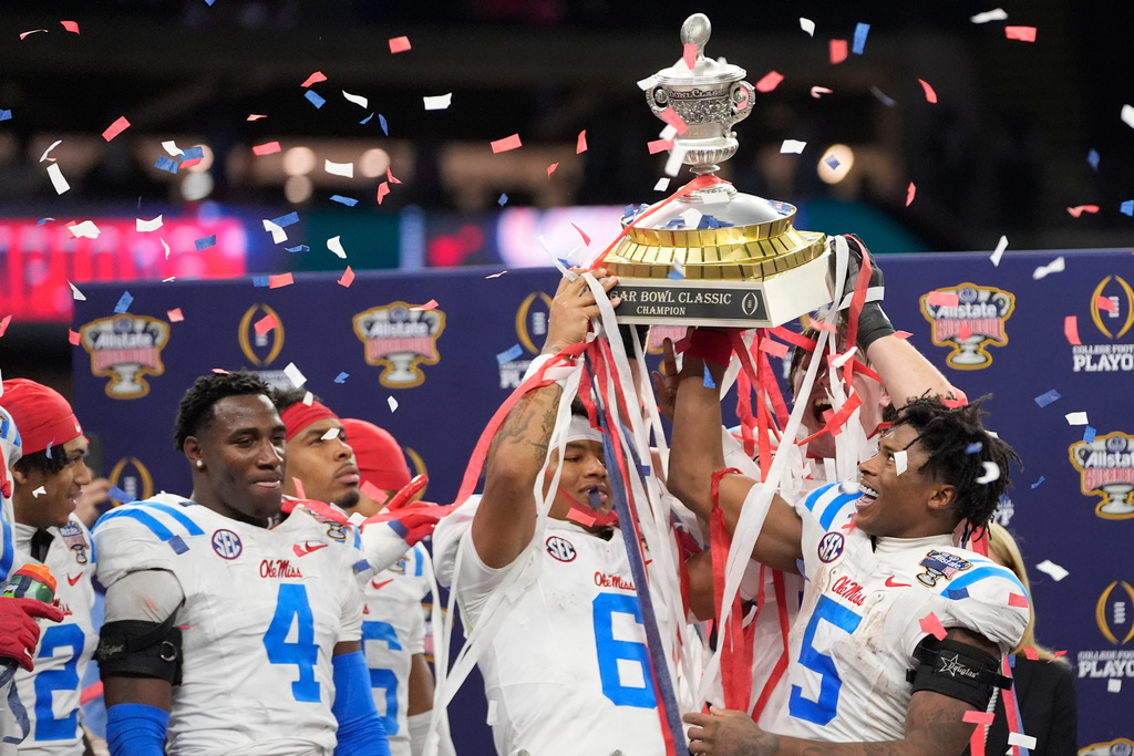 Mississippi platers and coach celebrate a win against Georgia after the Sugar Bowl NCAA college football playoff quarterfinal game, Friday, Jan. 2, 2026, in New Orleans. (AP Photo/Gerald Herbert)
