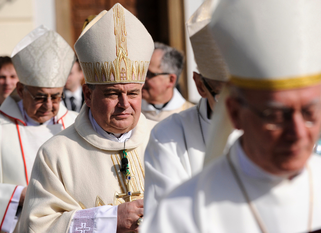 FILE - The new archbishop of Prague Dominik Duka, centre, walks in a procession towards St. Vitus Cathedral to take over the crosier from his predecessor Miloslav Vlk, left, in Prague Saturday, April 10, 2010. (AP Photo/CTK, Michal Krumphanzl, file)