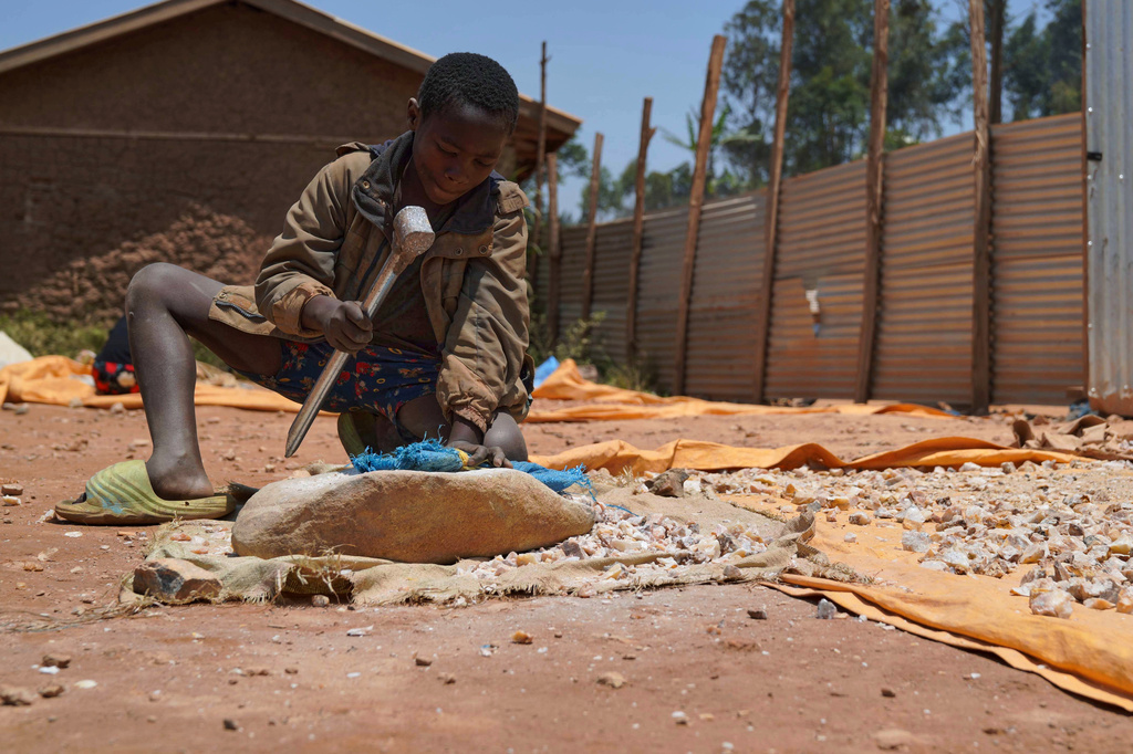 Isaac Batisa 11 years old, searches for gold at a mining site in Iga-Barrière, Ituri province, eastern Congo, Friday, Aug. 14, 2026. (AP Photo/Dieudonne Dirole)