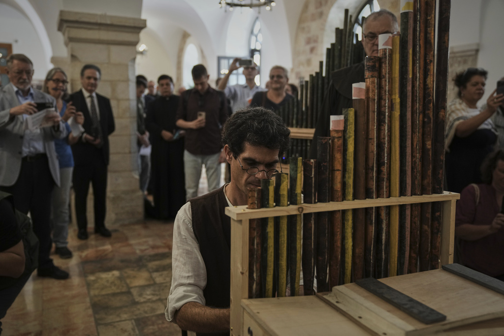 David Catalunya, a Valencian musician and musicologist plays an 11th-century organ that researchers say is the oldest in the Christian world was played for the first time in 800 years after restoration, in Saint Savior's Monastery of Jerusalem's Old City, Tuesday, Sept. 9, 2025. (AP Photo/Mahmoud Illean)