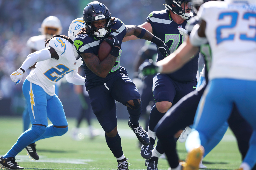 Seattle Seahawks running back Emanuel Wilson (23) runs up field during a touchdown reception in the first half of an NFL football game against the Los Angeles Chargers, Sunday, Oct. 4, 2026, in Seattle. (AP Photo/Kevin Ng)