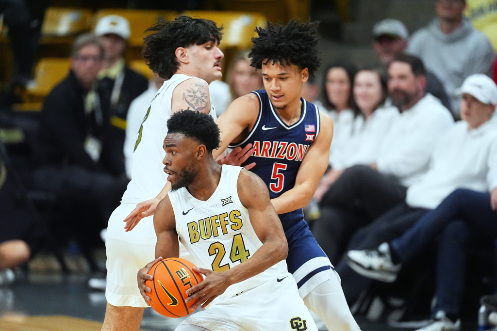 Colorado guard Barrington Hargress (24) fields a pass as Arizona guard Brayden Burries (5) defends in the first half of an NCAA college basketball game Saturday, March 7, 2026, in Boulder, Colo. (AP Photo/David Zalubowski)