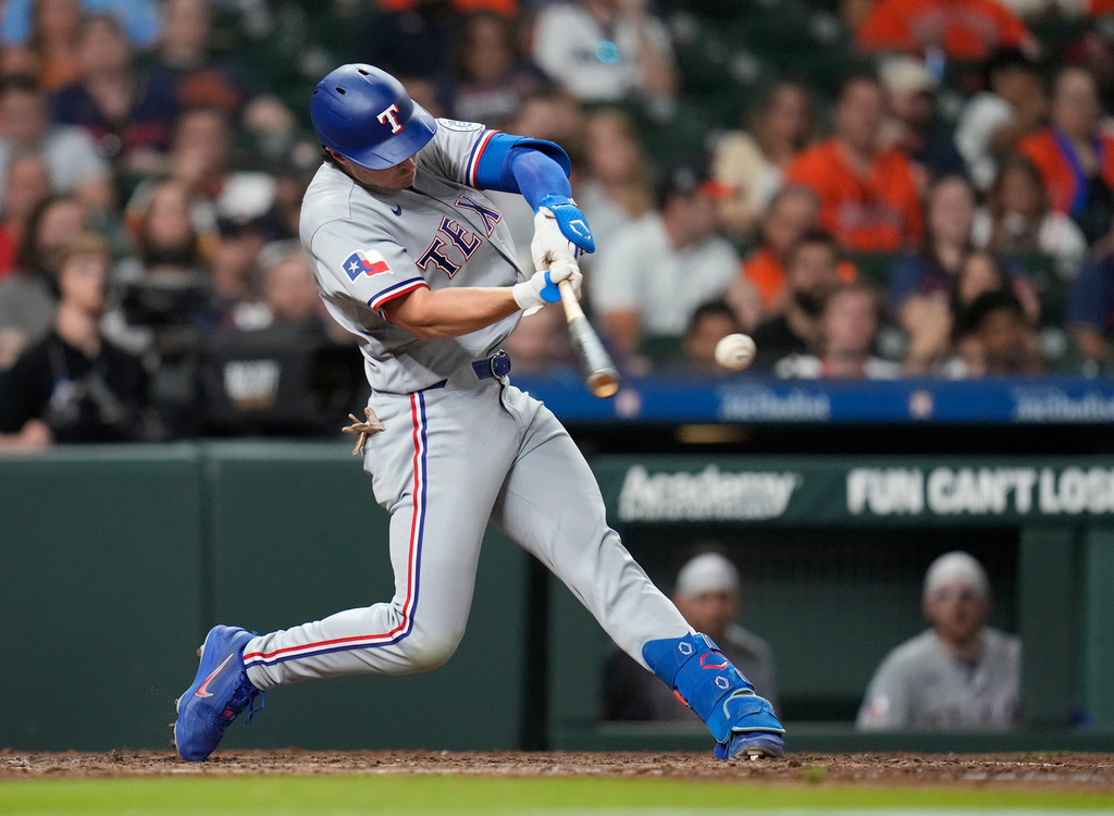 Texas Rangers' Justin Foscue gets the first hit of the night against Houston Astros starting pitcher Spencer Arrighetti during the eighth inning of a baseball game, Friday, May 15, 2026, in Houston. (AP Photo/Karen Warren)